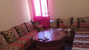 A living room with a sofa set, a coffee table, and a patterned rug. - Nice apartment in marakech, for a good stay  (Marakech)