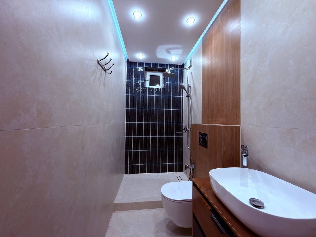 A modern bathroom with a shower, toilet, and vanity.