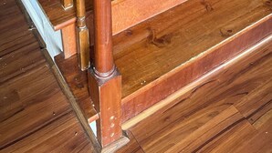 A wooden staircase with a handrail and a landing. - A quiet lakeside home for family, business, or both to relax or be productive. (Virginia Beach)