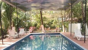 A swimming pool with a clear view of the sky and surrounding greenery. - Dom Pedros Haven Resort - Tranquil Retreat by the Sea (Majorda)