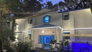 A building with a blue door, a blue window, and a blue awning. - Dom Pedros Haven Resort - Tranquil Retreat by the Sea (Majorda)