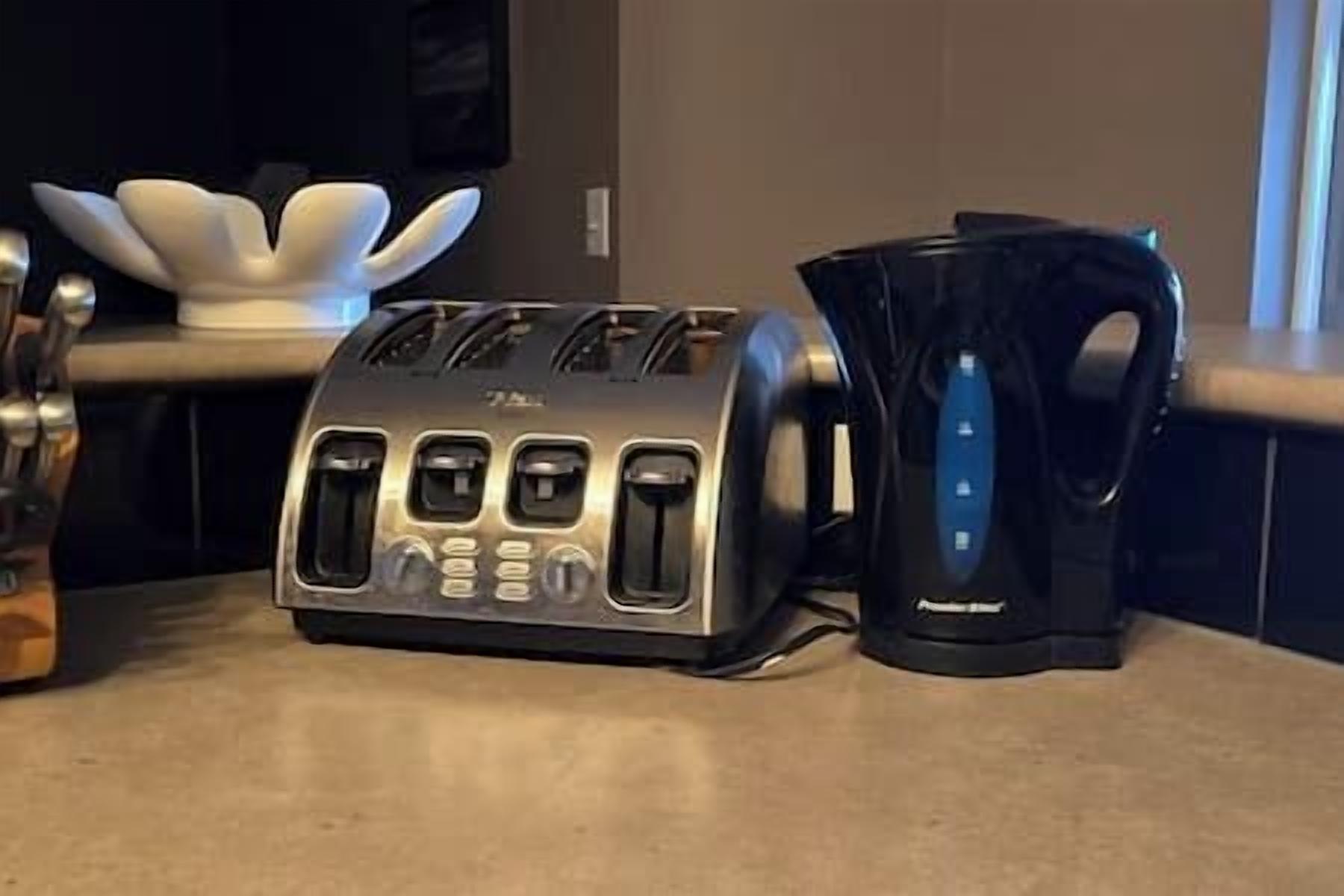 A toaster and a coffee maker on a kitchen counter.