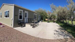 A single-story house with a number 3002 on the door, a driveway, and a basketball hoop in the yard. - The Guesthouse (Great Falls)