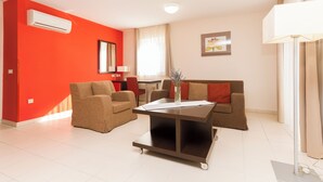 A modern living room with two sofas, a coffee table, and a dining area.