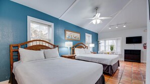 A hotel room with two beds, a ceiling fan, a TV, and a window with blinds. - Ibis Suite | Bright Hideaway, Hot Tubs, Steps from Duval! (Key West)