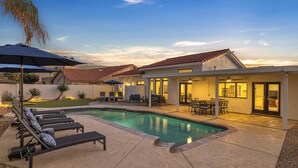 A residential backyard with a swimming pool, lounge chairs, and a patio area. - Modern and Classy 4 Bdrm N. Scottsdale Retreat! (Scottsdale)