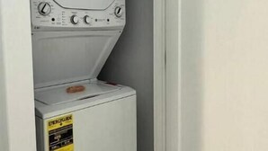 A compact washer and dryer unit in a small space.
