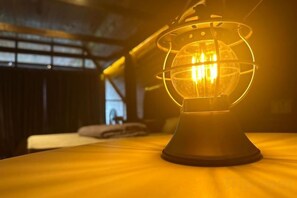 A table lamp with a spherical glass shade on a table. - Sankara Garden (Seremban)