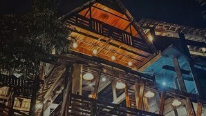 A multi-level wooden structure with visible balconies and a staircase. - Sankara Garden (Seremban)
