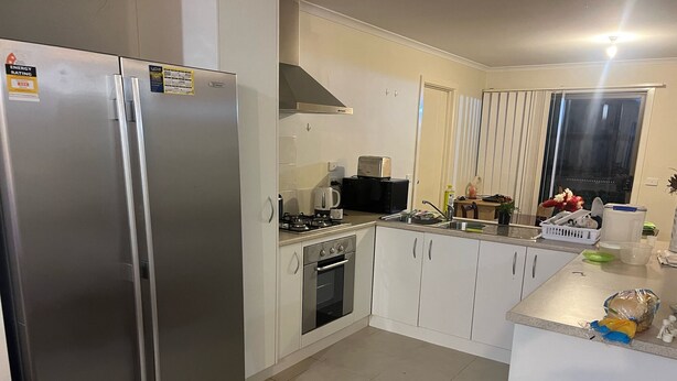 A modern kitchen with a stainless steel refrigerator, a stove, and a sink. - Quiet Abode with convenience. 3 Large bedrooms, whole house. (Melton South)