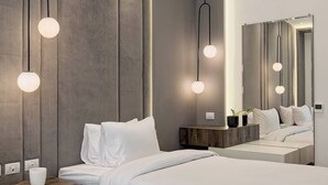 A modern hotel room with two beds, a large mirror, and pendant lighting. - Luxurious 3 bedrooms with Private Sauna & Jacuzzi in the prestigious Korba,Cairo (Cairo Governorate)
