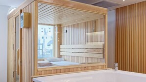 A modern bathroom with a wooden bath tub, a large mirror, and a wooden vanity. - Luxurious 3 bedrooms with Private Sauna & Jacuzzi in the prestigious Korba,Cairo (Cairo Governorate)