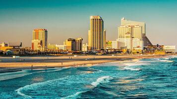 A coastal cityscape with prominent buildings including the Atlantic Palace and Taj Mahal hotels.