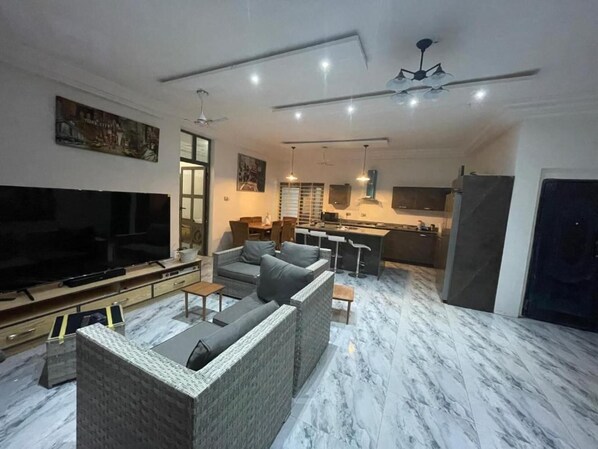 Relax in this stylish living space with a flat-screen TV, comfortable sofa, and dining area.