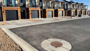 A row of modern, multi-story residential buildings with large windows and balconies.