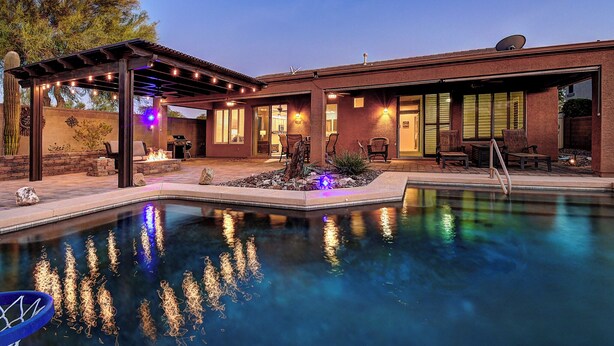 A modern house with a swimming pool, patio, and outdoor seating area. - Anthem Getaway with Backyard Oasis!  (New River)
