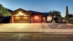 A residential house with a garage, driveway, and a cactus garden. - Anthem Getaway with Backyard Oasis!  (New River)