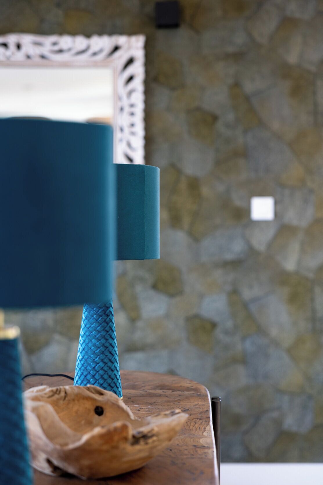 A chair with a blue cushion and a textured blue fabric.