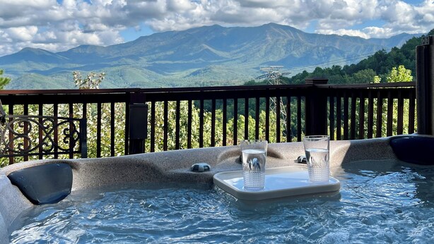 A hot tub with a mountain view, a wooden deck, and a railing. - Beautiful Cabin in Chalet Village. Hot Tub, 3 Decks, Stunning Mountain Views  (Gatlinburg)