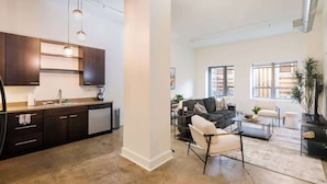 A modern apartment with a kitchen, living room, and dining area. - Historic 2BR Loft: Private Terrace & Free UFC Gym (Pittsburgh)