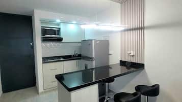 Fridge, stovetop, coffee/tea maker, cookware/dishes/utensils