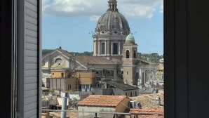 A view of a historic building with a dome and bell tower, surrounded by other buildings and a clear sky. - Chasing the Stars Spanish Steps Boutique Suite (Rome)
