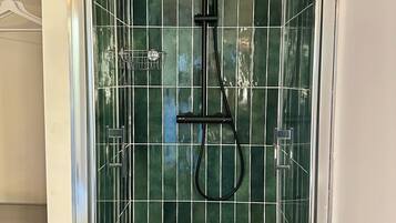 Een douche, handdoeken, zeep, toiletpapier