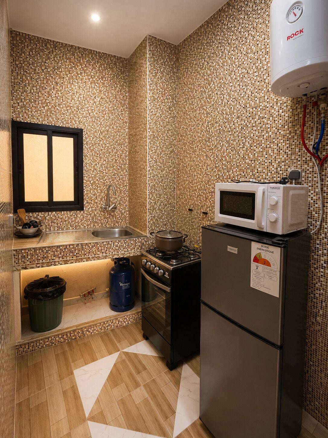 A compact kitchen with a microwave, stove, and refrigerator.