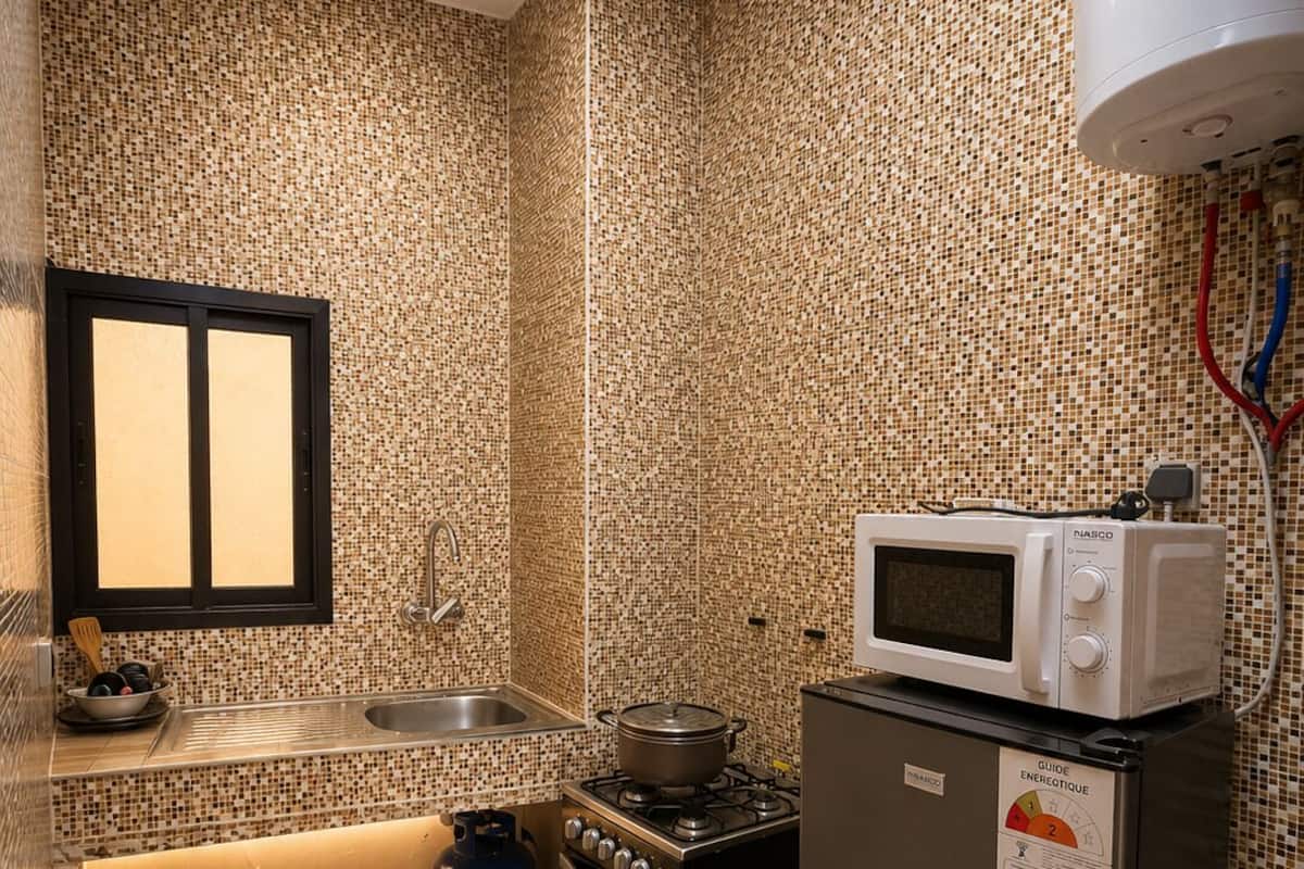 A compact kitchen with a microwave, stove, and refrigerator.