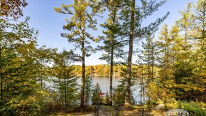 A natural landscape with a lake, trees, and a sign that reads "Cayne's." - Darling 3 bed 2 bath cottage on Lake Joseph with Bunkie! NW Exposure! Boathouse (Seguin)
