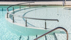 A clear swimming pool with a curved metal railing. - Arden Parks Signy L'Abbaye (Signy-l'Abbaye)