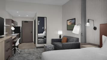 Et moderne hotelværelse med seng, skrivebord, stol og sofa.