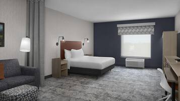 A hotel room with a bed, a desk, a chair, a sofa, and a large window.