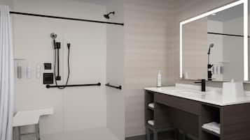 Un baño moderno con ducha, tocador y un espejo grande.