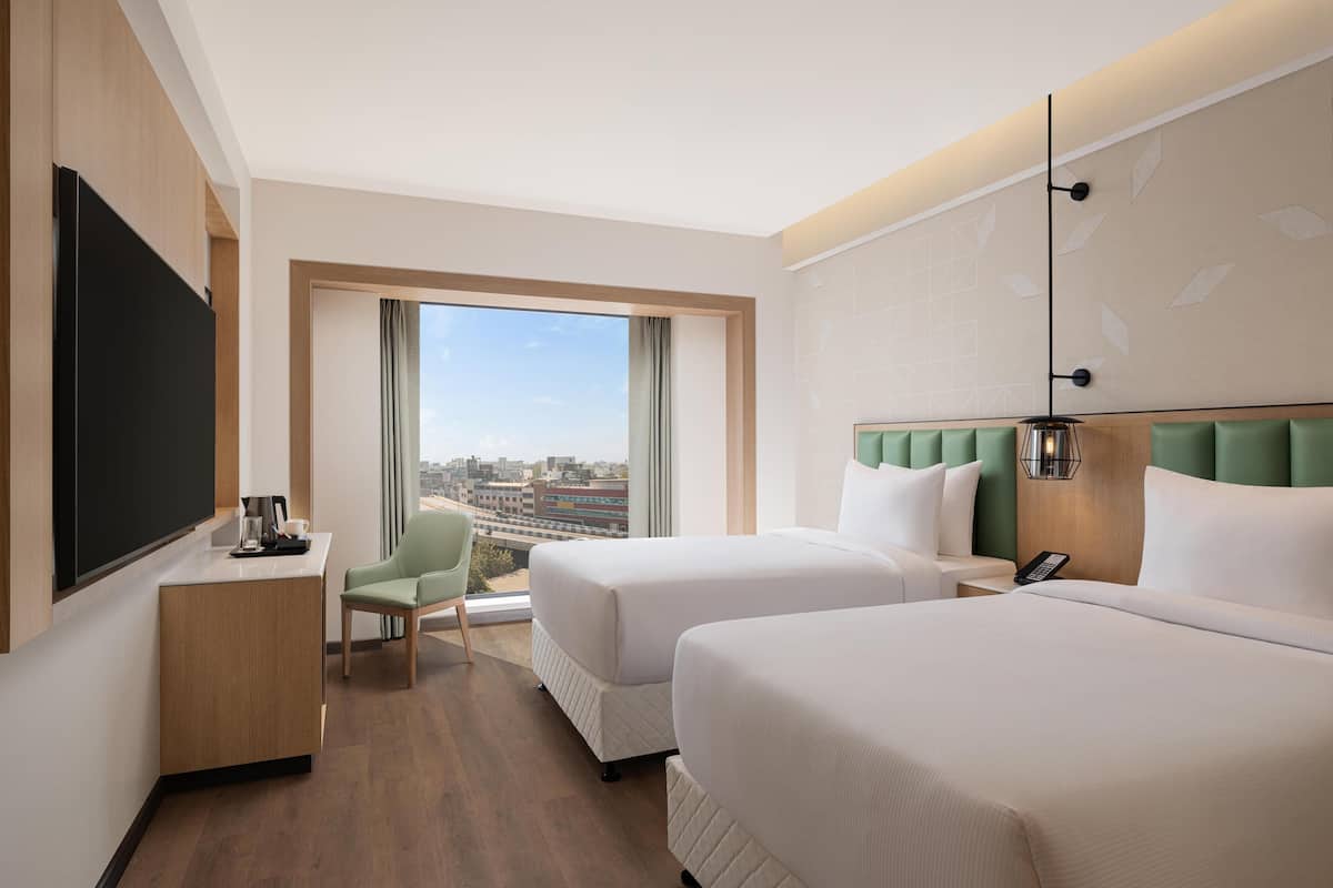 Twin guest room city view | Egyptian cotton sheets, premium bedding, down comforters