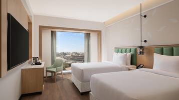 Twin guest room city view | Egyptian cotton sheets, premium bedding, down duvets, memory-foam beds