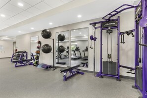 A gym with exercise equipment, mirrors, and a weight rack. - Home2 Suites By Hilton Harrisonburg University (Harrisonburg)