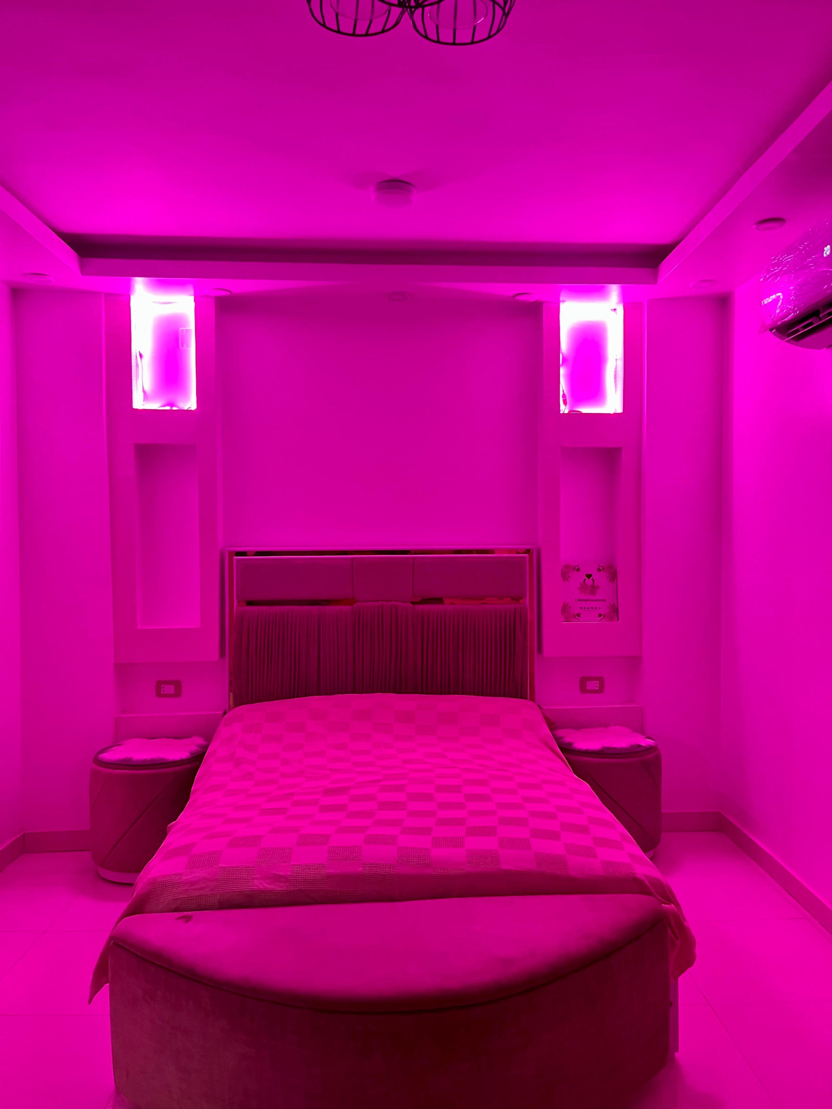 Una camera da letto con un letto grande, due comodini e una testiera.