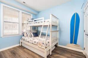 A bunk bed with a ladder, a surfboard, and a window with blinds. - Sunset Island 35 Fountain Drive West, Unit 3D (Ocean City)