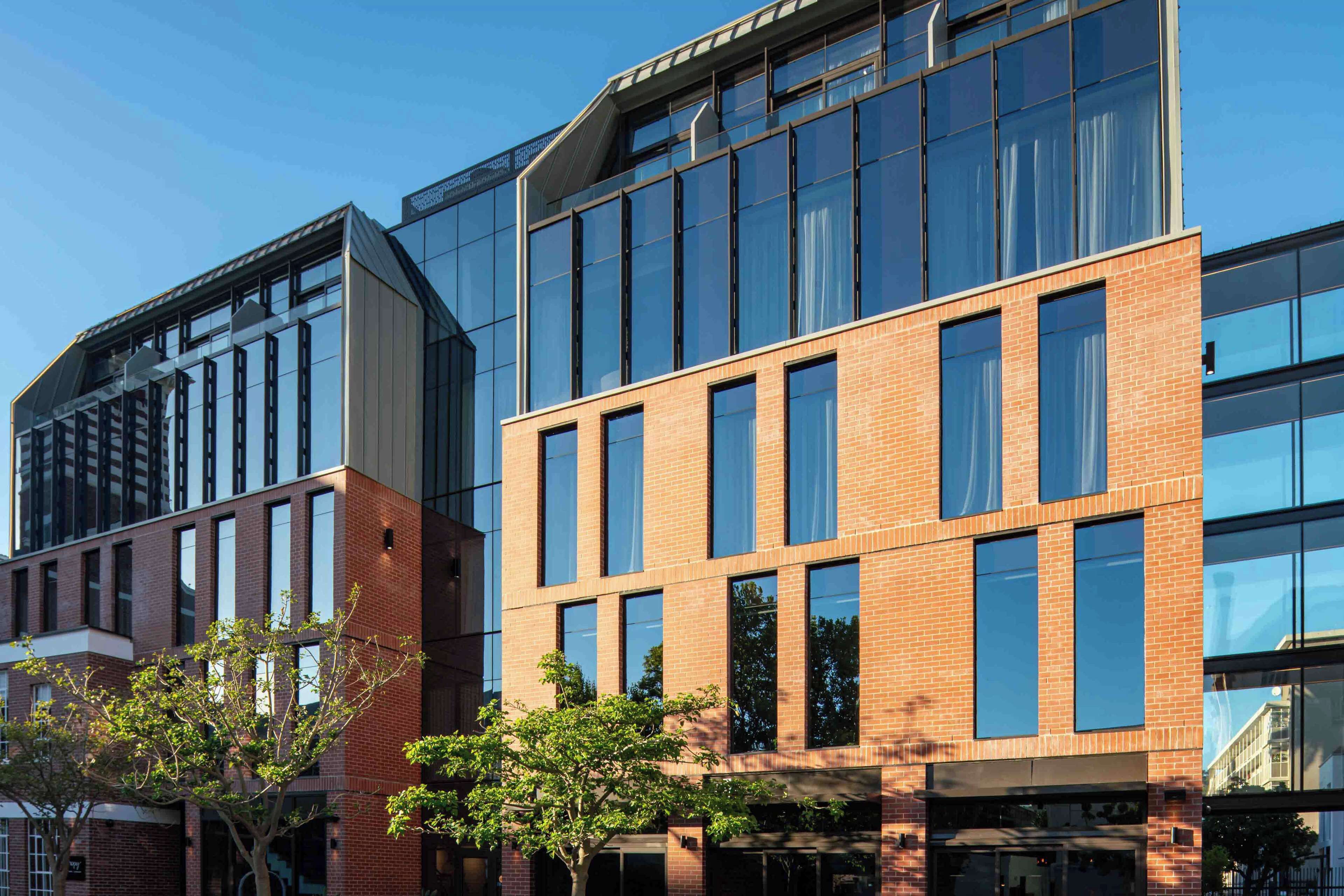 A modern building with large windows and a brick facade.