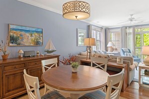A dining area with a round table, chairs, and a decorative centerpiece.