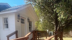 A wooden deck leading to a white house with a number '2589' on the side.