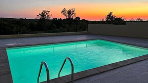 A rectangular pool with clear water, surrounded by a tiled deck. - Awesome home in Murvica Gornja (Murvica Gornja)