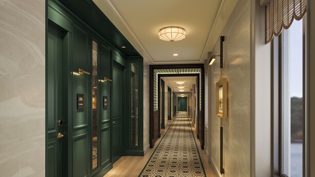 A long, narrow hallway with dark green doors, patterned carpet, and a series of lights along the ceiling. - DELAMAR MYSTIC (Mystic)
