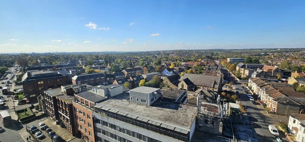 A cityscape with a mix of residential and commercial buildings, including a prominent church steeple. - Modern & Lovely 2 Bed in London (London)