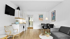 A modern living space with a kitchen, dining area, and seating area. - Lovely apartment in Nexø with WiFi (Nexø)