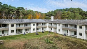 A modern, multi-story building with a flat roof and solar panels. - Lovely apartment in Nexø with WiFi (Nexø)