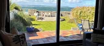 Splash Cottage Beach house with sea touching back garden