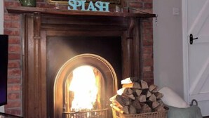 Une cheminée surmontée d’une enseigne portant l’inscription « SPLASH », un mur en briques et une porte sur la droite.