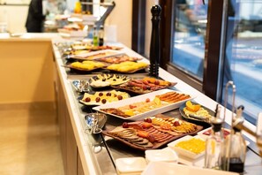 A buffet with various food items and condiments. - Baytur Resort & Spa (Cholpon-Ata)